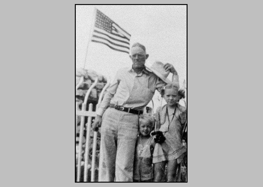 Adron Terry Adrienne standing by a flag which has 48 stars