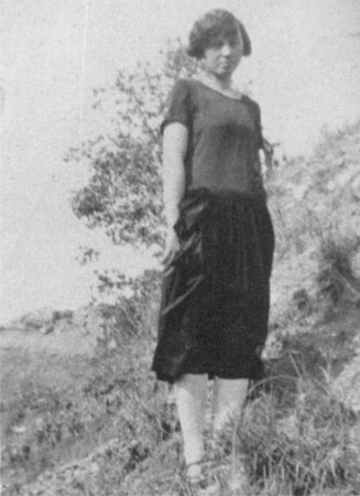 <johnie viola downer posed on hill side wearing black skirt white stockings>