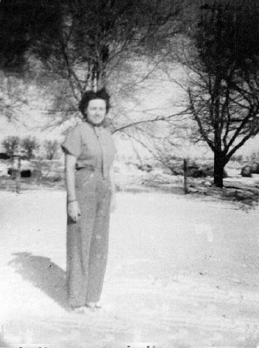 <trim johnie turner standing in snow in front yard of portales farm>