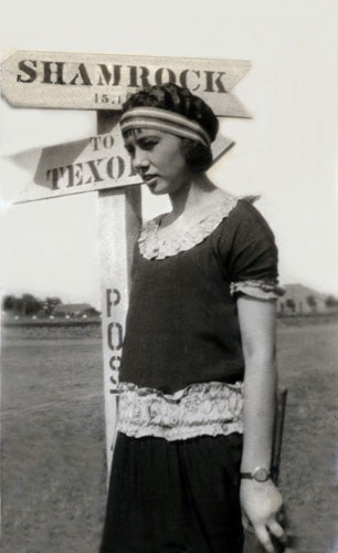 <Mom Johnie posed by shamrock road sign. Favorite Creative Pose Photoshopped restored by terry>