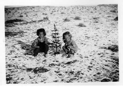 <cousins donna and sheila rombold with chirstmas tree Location: probably Gallup, NM>